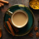 Masala tea and spices on dark gray background, top view