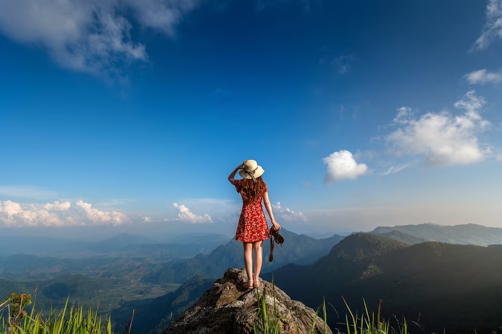 woman-hand-holding-camera-standing-top-rock-nature-travel-concept_335224-887