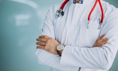 Young handsome physician in a medical robe with stethoscope